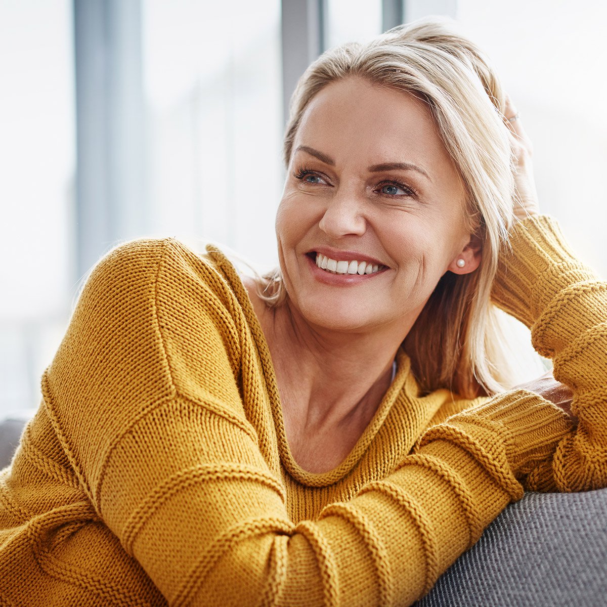 juvederm patient model smiling sitting on a couch