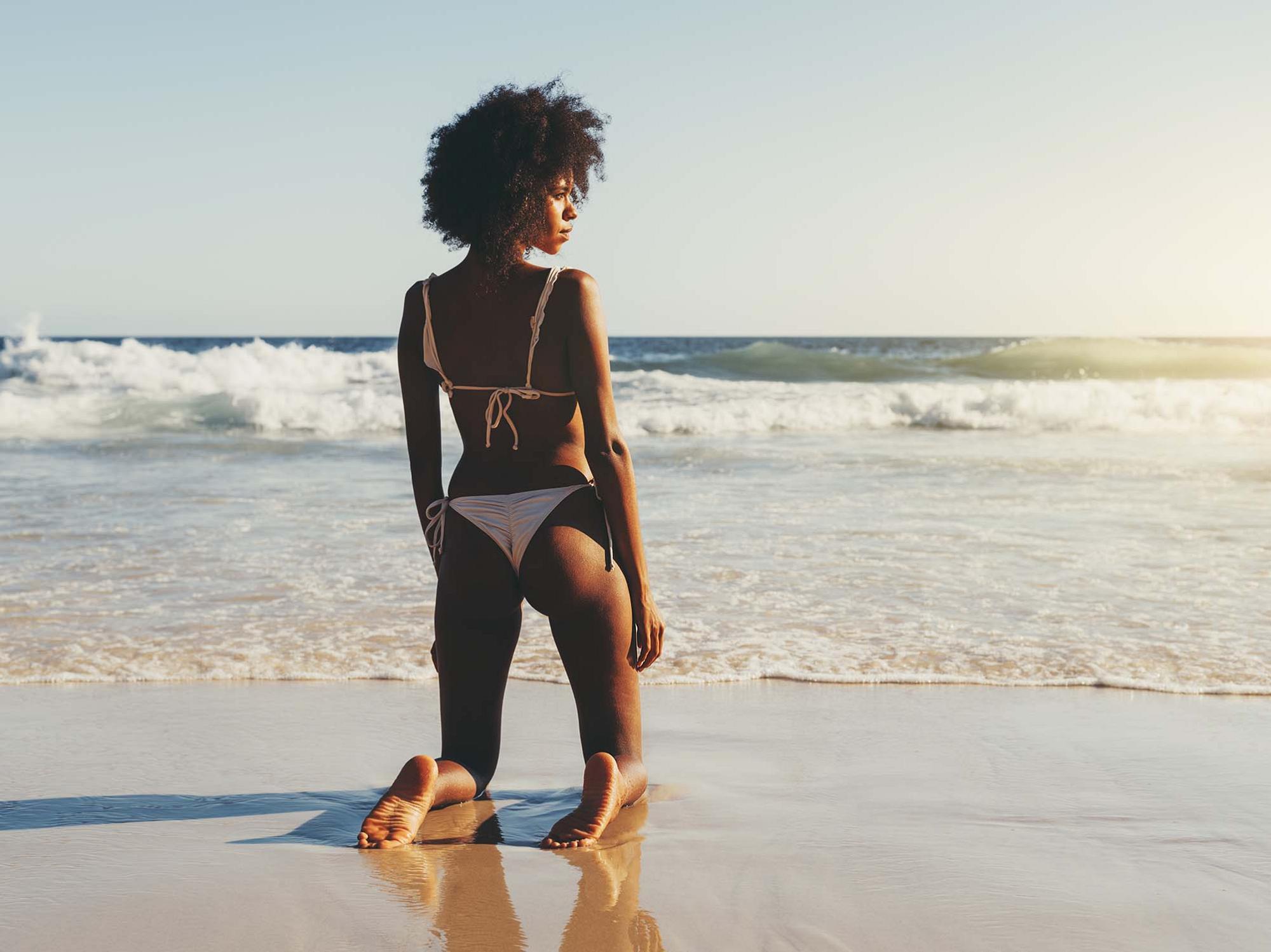 laser hair removal model wearing a bikini on the beach